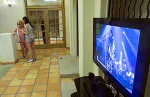 A video featuring Michael Jackson plays at a home where the entertainer used to live on Palomino Lane June 25, 2011. The homeowner opened a portion of the home to the public to mark the second anniversary of the entertainer's death.