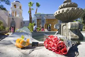 Flowers are left by a fountain outside a home where entertainer Michael Jackson used to live on Palomino Lane Saturday, June 25, 2011. The homeowner opened a portion of the home to the public to mark the second anniversary of the entertainer's death.