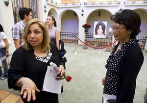 Didi Lima, left, the homeowner's representative, talks with guests at a home where entertainer Michael Jackson used to live on Palomino Lane Saturday, June 25, 2011. Julie Hereford listens at right. The homeowner opened a portion of the home to the public to mark the second anniversary of the entertainer's death.