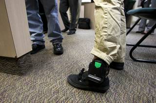 A juvenile offender is shown after being outfitted with a SecureAlert GPS ankle-bracelet in a courtroom at the Family Court building Thursday, June 30, 2011. 