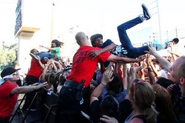 Concertgoers crowd surf during the Vans Warped Tour as it made a stop at the Plaza Parking Lot in Las Vegas Thursday, June 30, 2011.