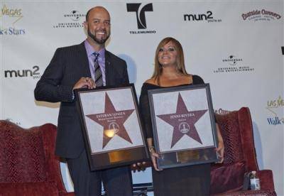 Singer Jenni Rivera, right, and her husband, former Major League Baseball pitcher Esteban Loaiza, pose for a photograph with replicas of Las Vegas Walk of Stars presented to them during an official ceremony Friday, July 1, 2011, in Las Vegas. The actual stars will be embedded in the sidewalk in front of the MGM Grand Casino along Las Vegas Boulevard on Saturday. 