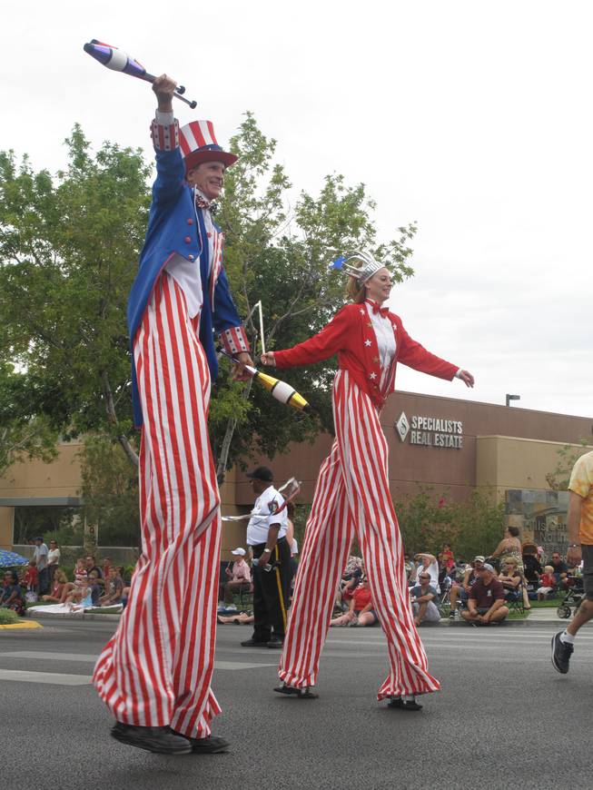 Two patriotic stilt walkers entertain crowds along the parade route Monday at Summerlin's 17th annual Patriotic Parade.