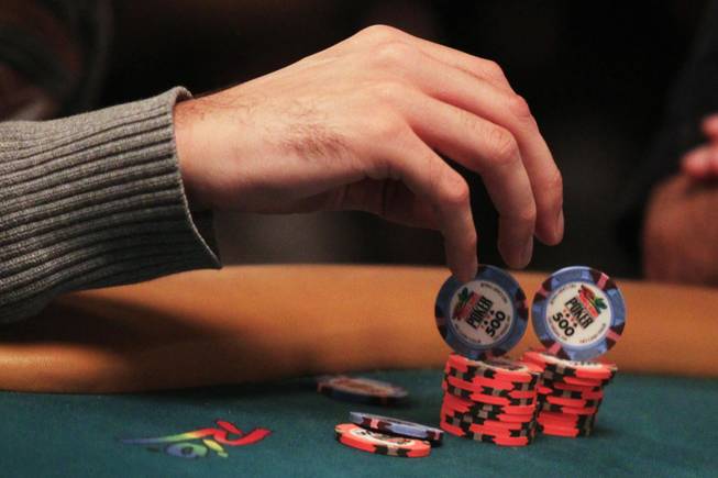 A competitor plays with his chips during play at the 2011 World Series of Poker Friday, July 15, 2011.