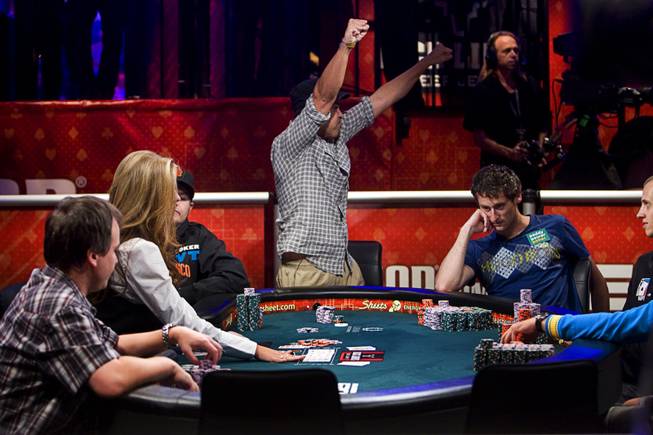 Khoa Nguyen of Canada celebrates after going "all in" and winning the hand during Day 8 of the World Series of Poker $10,000 buy-in, no-limit Texas Hold 'em Main Event at the Rio Tuesday, July 19, 2011. Eoghan O'Dea of Ireland is at right.