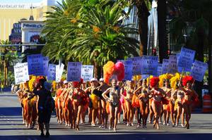 Showgirls from "Jubilee!" at Bally's march up the Strip during a publicity stunt Thursday, July 21, 2011, to praise Caesars Entertainment's policy of not charging resort fees.