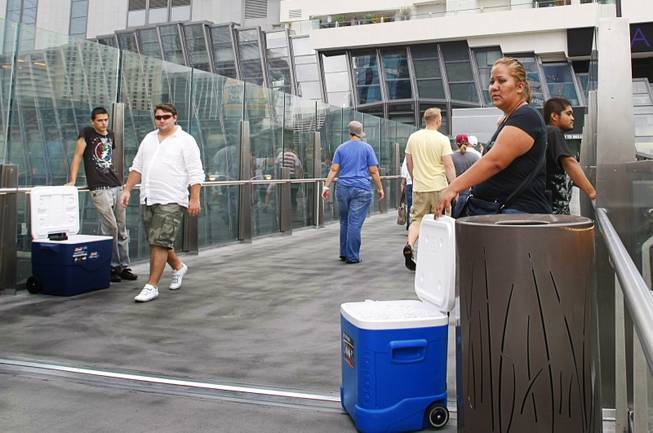 Vendors sell water for $1 per bottle on a pedestrian overpass by the Cosmopolitan on the Las Vegas Strip Sunday July 24, 2011.