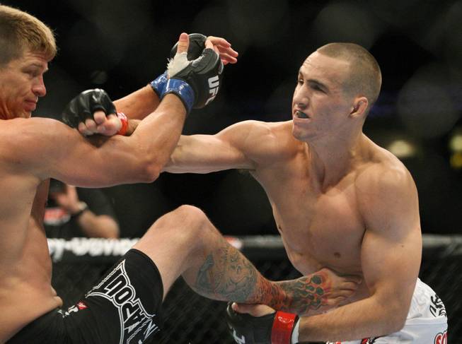 Rory MacDonald, right, hits Mike Pyle in the main card welterweight bout during UFC 133 on Saturday, Aug. 6, 2011, in Philadelphia.