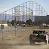 A trophy truck drives through a speed zone in the main pit area during the SCORE Primm 300 off-road race on Sept. 11, 2010. 
