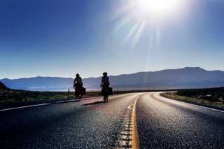 Norwegians Frida Devold and Gunnvor Ness ride their bikes on Highway 50 east of Eureka on Tuesday, Aug. 9, 2011.