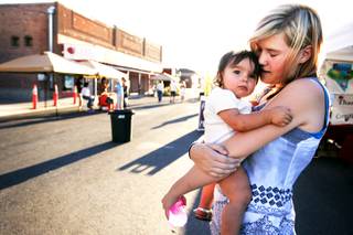 Tabitha Johnson, 16, holds her one-year-old niece Jordan Brazil while shopping at the Center Street Market in downtown Fallon Tuesday, August 9, 2011.