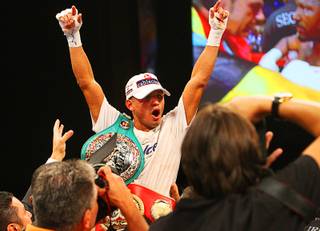 Abner Mares of Mexico celebrates after being named the winner in his fight against IBF bantamweight champion Joseph Agbeko of Ghana at the Hard Rock on Saturday, Aug. 13, 2011. Mares took the title by majority decision after 12 rounds.
