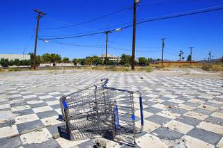 A shopping cart sits in an empty lot on Water Street in Henderson on Tuesday, Aug. 16, 2011.