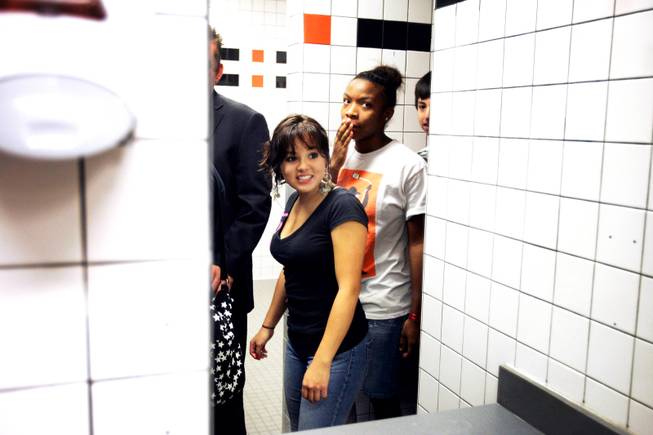 Juniors Sarahi Berrelleza, center, and Tichina Savoy, right, tour the renovated bathrooms at Chaparral High School on Thursday, August 18, 2011.