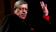 Representatives of Jerry Lewis have said reports of his returning to the Muscular Dystrophy Association Telethon are false. If so, why is an orchestra being summoned to perform with him for the Labor Day showcase at South Point?