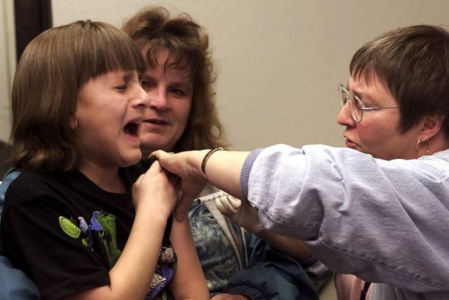 Sarah Meza reacts as she gets a vaccination shot at the Clark County Health District on December 29, 2000.