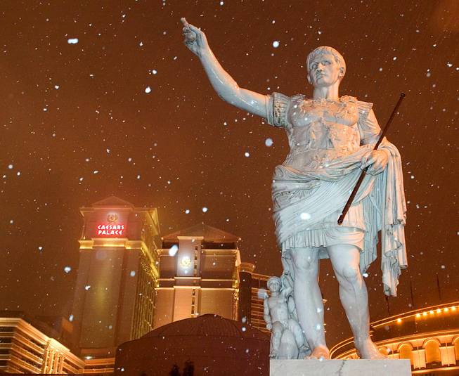 Snow falls around a statue of Caesar in front of Caesars Palace early Tuesday, December 30, 2003. 