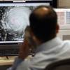 Hurricane specialist Dan Brown reviews the tracks and intensity of Hurricane Irene at the National Hurricane Center on Friday, August 26, 2011, in Miami. 