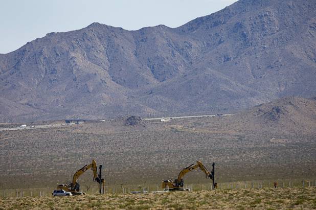 Machines bore holes for poles that will hold mirrors at the Ivanpah Solar Electric Generating System construction site just south of Primm in California Monday, August 29, 2011. The design allows the poles and mirrors to be placed without concrete pads minimizing the environmental impact.
