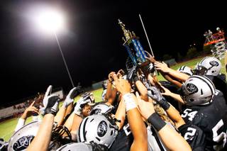 Palo Verde High football players celebrate their 14-7 victory against visiting Arbor View Thursday, Sept. 1, 2011, by holding up the Thursday Night Lights trophy. The winner of the Thursday television game each week receives a trophy.