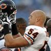 Chicago Bears linebacker Brian Urlacher puts on his helmet before an NFL preseason game between the Chicago Bears and the Tennessee Titans on Saturday, Aug. 27, 2011, in Nashville, Tenn.