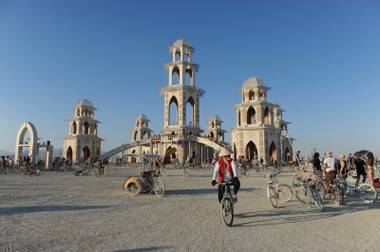 In this Sept. 1, 2011, photo, people gather at the temple during the Burning Man festival in northern Nevada. The temple, built for the festival in downtown Reno, was hauled in pieces earlier this month on 20 flatbed trucks to the Black Rock desert, where about 140 volunteers from around the world helped with construction. The annual event — marked by public art, self-expression and an eight-day experiment in community — sold out for the first time in its history.