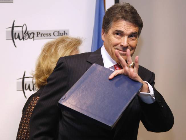 Republican presidential candidate Gov. Rick Perry of Texas, shown here waving after a news conference in Tulsa, Okla., on Aug. 29, could become an unlikely friend to Nevadans seeking to raise taxes here.