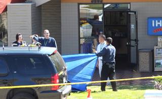 Officials investigate the scene of a shooting in an IHOP restaurant in Carson City on Tuesday, Sept. 6, 2011.  