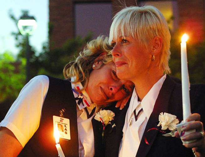United Airlines flight attendants Deanna Rhodes, left, and MaryAnne Houser, vice president of the Association for Flight Attendants in Las Vegas, console each other as they join hundreds of police and fire personnel at the Clark County Government Center amphitheater during a memorial service Monday, Sept. 17, 2001, where Las Vegas' public safety community honored the firefighters and police officers lost in the terrorist attacks.