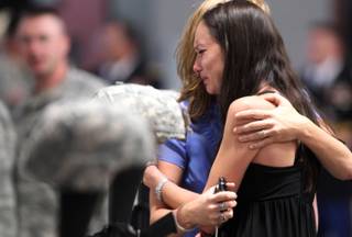 Master Sgt. Christian Riege's fiance Stacia Greene is consoled by an unidentified friend before a memorial ceremony in Carson City on Sunday, Sept. 11, 2011. Three Nevada National Guard members who were killed by a gunman in an IHOP restaurant were honored during the private ceremony. 