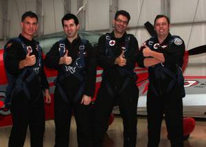 Bill "Stroke" Tracy and Richard "Tex" Coe pose with hypnotist Marc Savard and Sun columnist John Katsilometes at Sky Combat Ace.