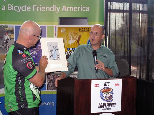 Regional Transportation Commission General Manager Jacob Snow, left, receives the Bicycle Friendly Business award from League of American Bicyclists President Andy Clark at the Interbike trade show, Sept. 15, 2011.