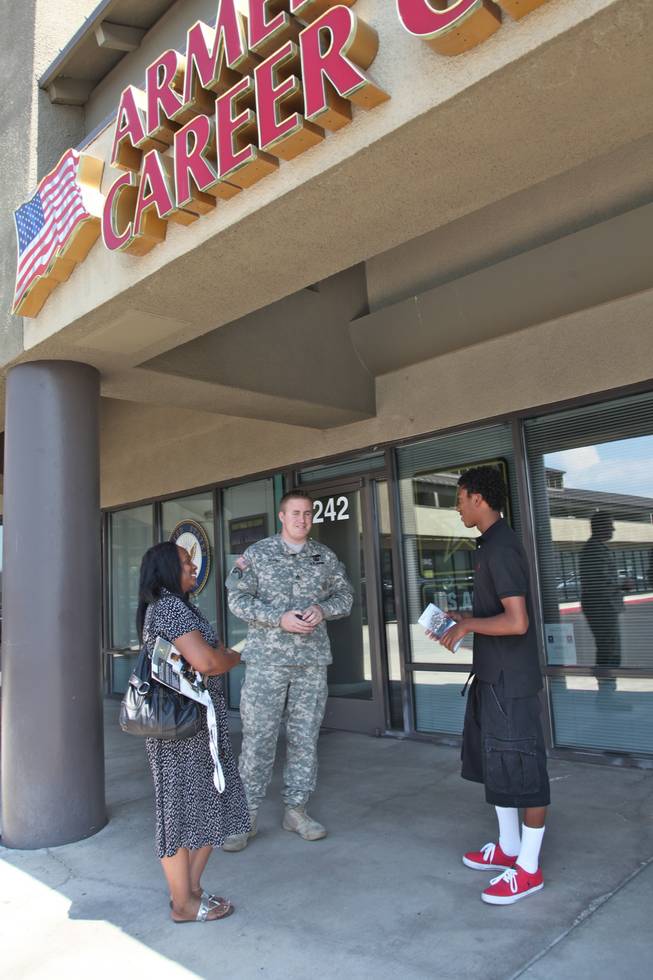 Sgt. Jonathan Quarry, in charge of the Decatur Boulevard military recruiting station, talks with Brandon Smith, 18, and Smith's mother, Carolyn Evans about opportunities in the armed forces.