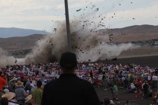 A P-51 Mustang airplane crashes into the edge of the grandstands at the Reno Air show on Friday, Sept. 16, 2011. The World War II-era fighter plane flown by a veteran Hollywood stunt pilot Jimmy Leeward plunged Friday into the edge of the grandstands during the popular air race creating a horrific scene strewn with smoking debris.