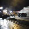 A shuttle buggy feeds rubberized asphalt into a paver during resurfacing of Interstate 15 between Tropicana Avenue and Charleston Boulevard Monday, Sept. 19, 2011. 