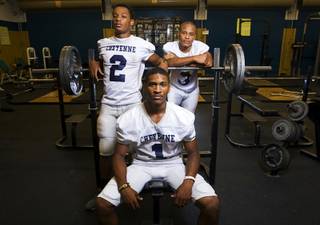 Cheyenne High School football players Kenneth Counts III (No. 1), Myloe Lewis (No. 2) and Tyler Spight (No. 3) pose in the weight room at the school in North Las Vegas on Tuesday, Sept. 20, 2011.
