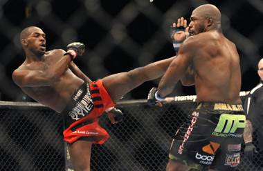 Jon Jones, left, of Endicott, N.Y., gets in a kick to the head of Rampage Jackson, of Irvine, Calif., during the first round of their UFC light heavyweight title bout, Saturday, Sept. 24, 2011, in Denver.