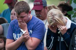 Two young people react while attending the Reno, Nev., memorial service for the victims of the Sept. 16 crash at the National Championship Air Races on Sunday, Sept. 25, 2011, in Reno.