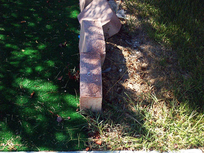 An artificial lawn, left, butts against natural grass in the Parks community in North Las Vegas Monday, Sept. 26, 2011.