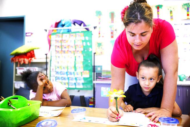 Kindergarten teacher Paula Barry helps Jasmine Ybarra with a drawing at Elizondo Elementary School in North Las Vegas on Thursday, Sept. 29, 2011.