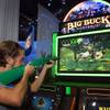 Matt Bourie of Miami tries out the Big Buck Hunter Pro video slot machine in the IGT booth during the first day of the Global Gaming Expo (G2E) convention at the Sands Expo Center Tuesday, Oct. 4, 2011.
