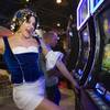 Amanda McIlvaine, dressed as Betty Boop, poses by a Betty Boop Fortune Teller video slot machine in the Bally Technologies booth during the first day of the Global Gaming Expo (G2E) convention at the Sands Expo Center Tuesday, Oct. 4, 2011.