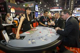Tala Marie deals a game called Cincinnati 7 Card Stud at a Shuffle Master booth during the first day of the Global Gaming Expo (G2E) convention at the Sands Expo Center Tuesday, Oct. 4, 2011.