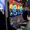 Casey Condrom plays the Aladdin video slot machine in the WMS Gaming booth during the first day of the Global Gaming Expo (G2E) convention at the Sands Expo Center Tuesday, Oct. 4, 2011.