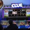 Show attendees play Clue-themed video slot machines in the WMS Gaming booth during the first day of the Global Gaming Expo (G2E) convention at the Sands Expo Center Tuesday, Oct. 4, 2011.