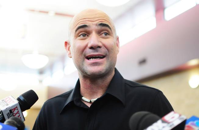 Andre Agassi talks with media after giving former Florida Gov. Jeb Bush and Gov. Brian Sandoval a tour of Andre Agassi College Preparatory Academy in the northern Las Vegas Valley on Wednesday, Oct. 5, 2011.
