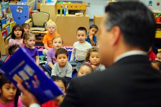 Gov. Brian Sandoval reads to schoolchildren as Principal Sherrie Gahn looks on at Whitney Elementary School on Thursday, Oct. 6, 2011, as part of the sixth annual Read for the Record, a nationwide literacy effort.