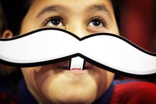 Leonardo Jalion, a fourth-grader at Paradise Elementary School, wears a Rebel mustache during the Rebel Reading Challenge Kickoff for fourth- and fifth-grade students at the Thomas & Mack Center in Las Vegas on Monday, Oct. 10, 2011.