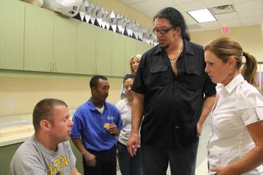 After advancing to another round on “Celebrity Apprentice,” Penn Jillette visits Opportunity Village to deliver a check worth $40,000 earned from his wins on the show.