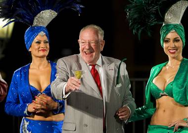 Former Las Vegas Mayor Oscar Goodman takes the stage with a martini and showgirls before driver introductions in front of the Bellagio on Thursday, Oct. 13, 2011. The IZOD IndyCar World Championship race is at Las Vegas Motor Speedway on Sunday.